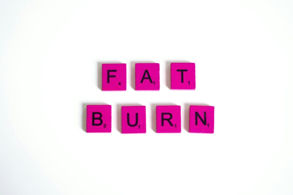 Pink scrabble tiles on a white background spelling 'Fat Burn'. Perfect for fitness and wellness concepts.
